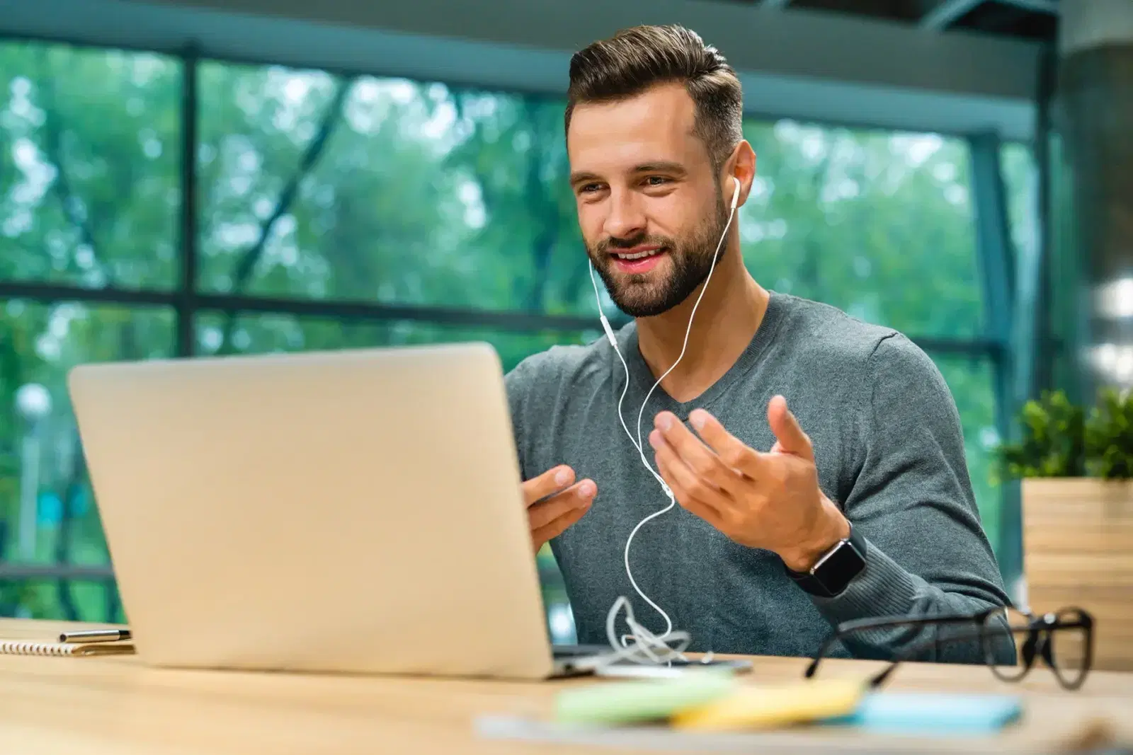 A man presenting on a video call from a laptop